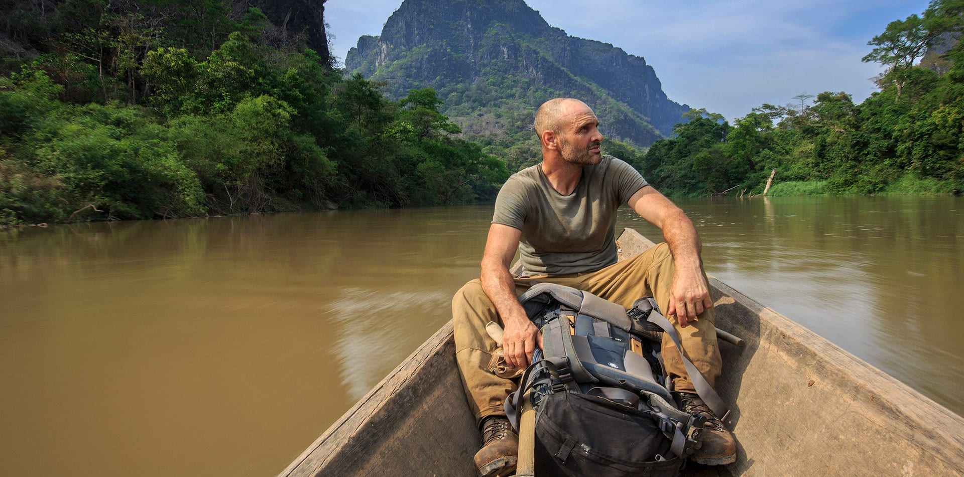 Survivalist Ed Stafford in a boat on the Amazon with his backpack
